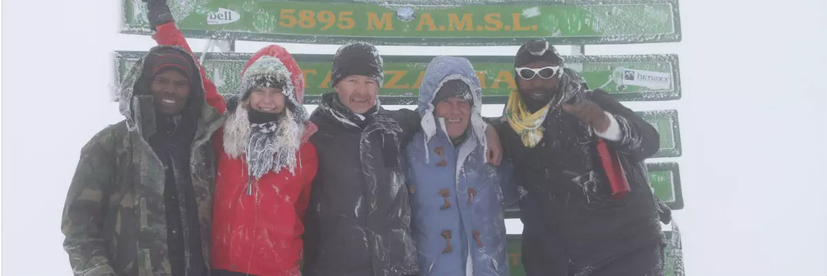 Roly Pitts at the summit in the snow